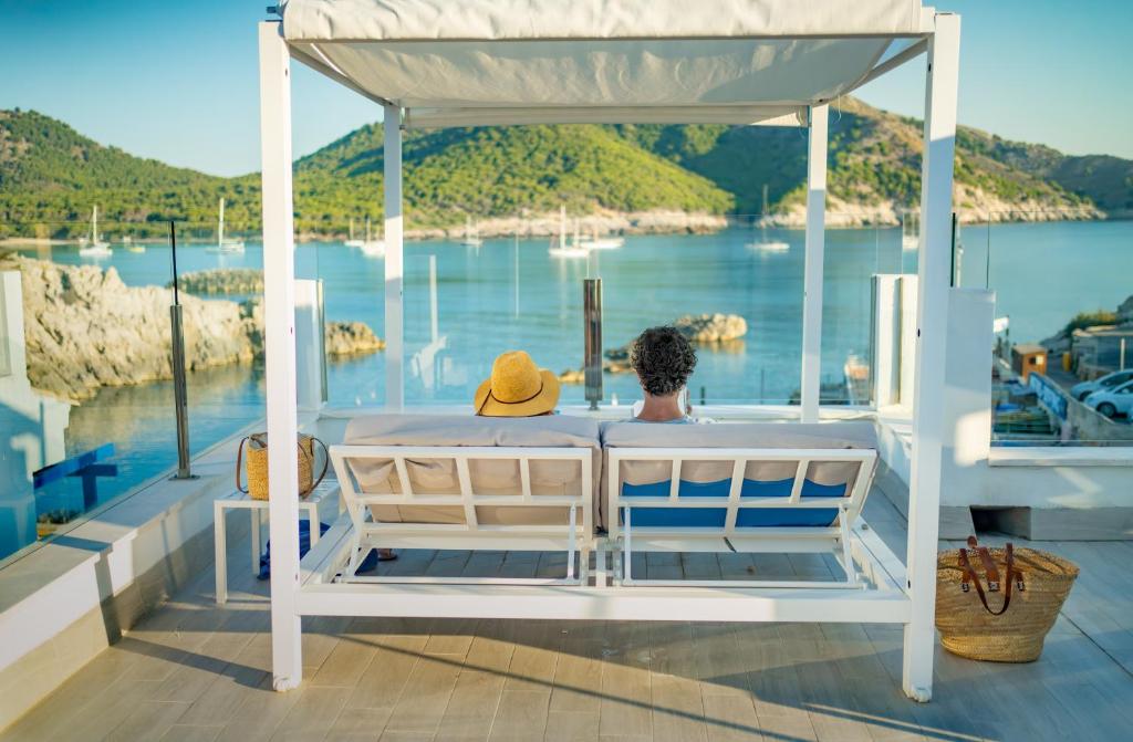 カラ・ラトハダにあるParque Nereida Suites Hotelの- 水辺の景色を望むボートのベッド1台
