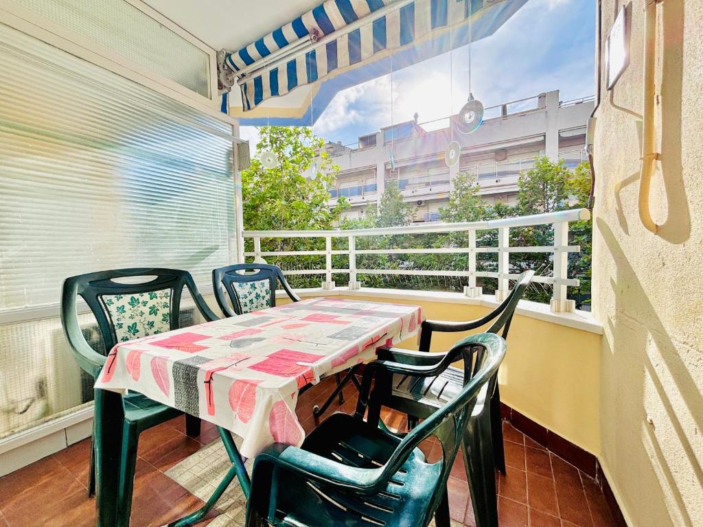 a table and chairs on a balcony with a window at COSTA DAURADA APARTAMENTS - Alboran II in Salou