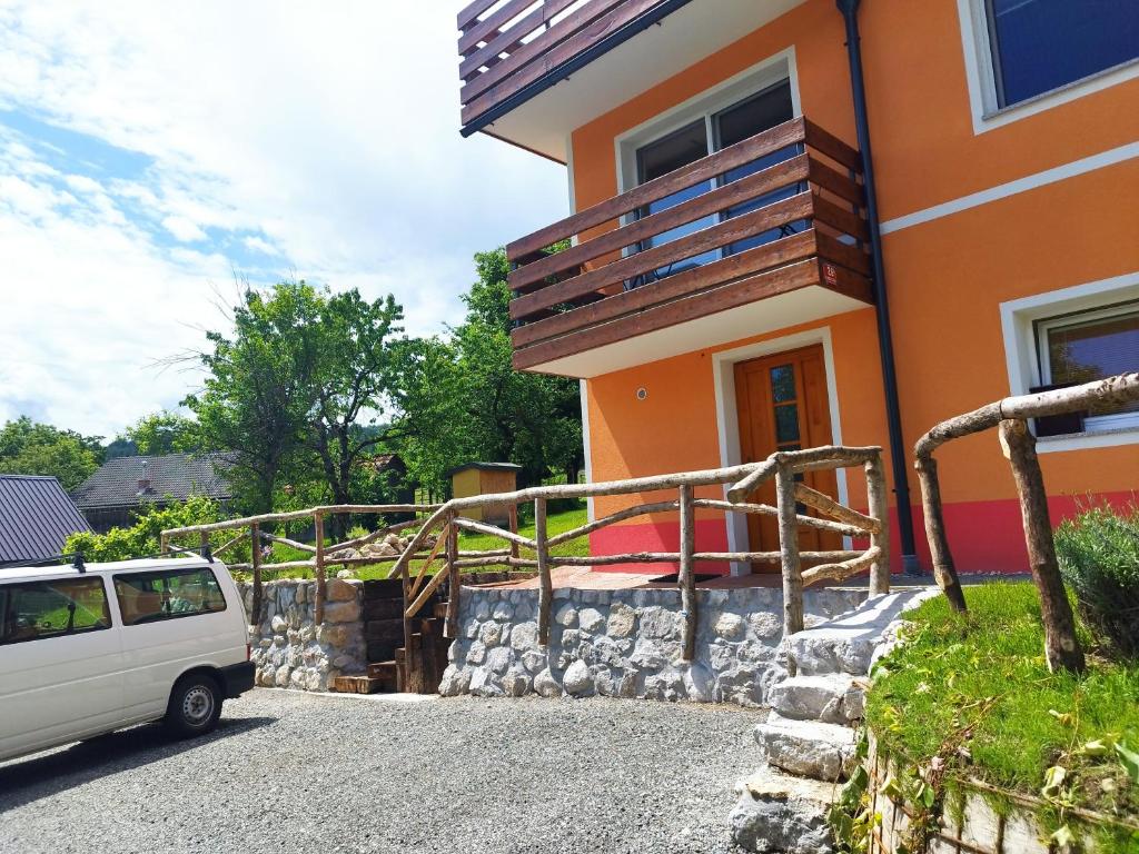 a van parked in front of a house at Tree in Bled