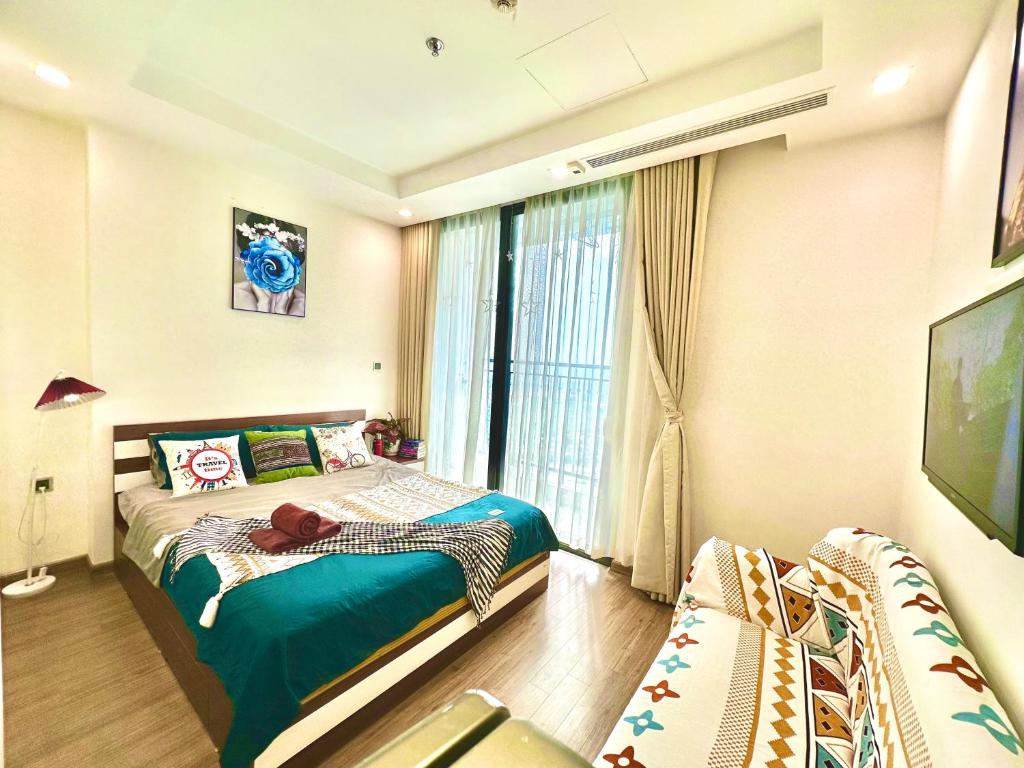 a small bedroom with a bed and a window at Deluxe Studio Next National Convention Centre And Marriott Hotel in Hanoi