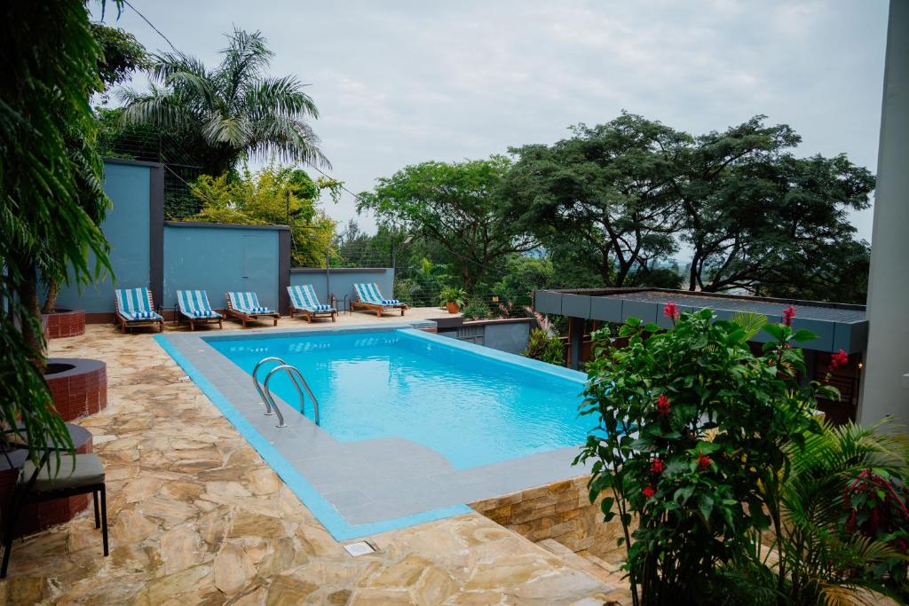 a swimming pool with lounge chairs around it at Greenside Hotel in Arusha