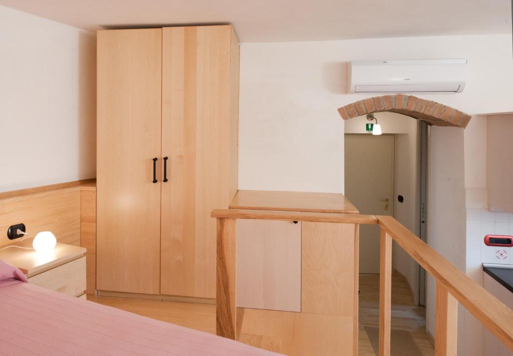 a kitchen with wooden cabinets and a stairway at La Sentinella Holiday House in Bracciano