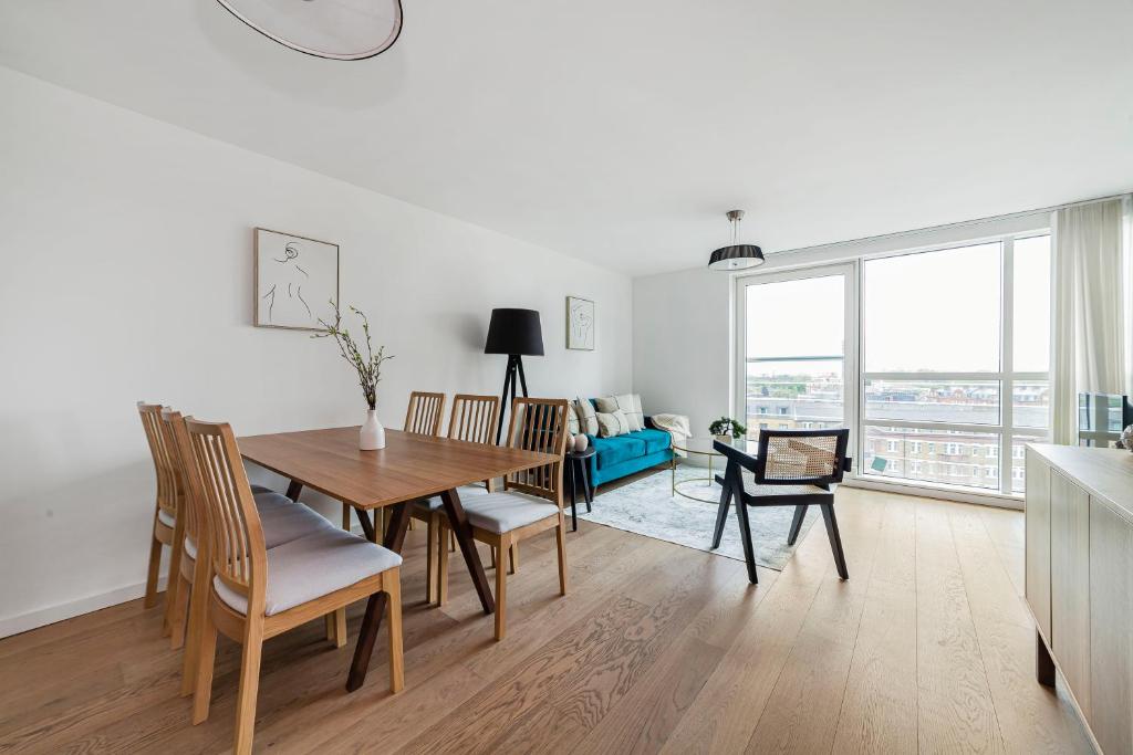 a dining room and living room with a table and chairs at The Lambeth Apartment in London