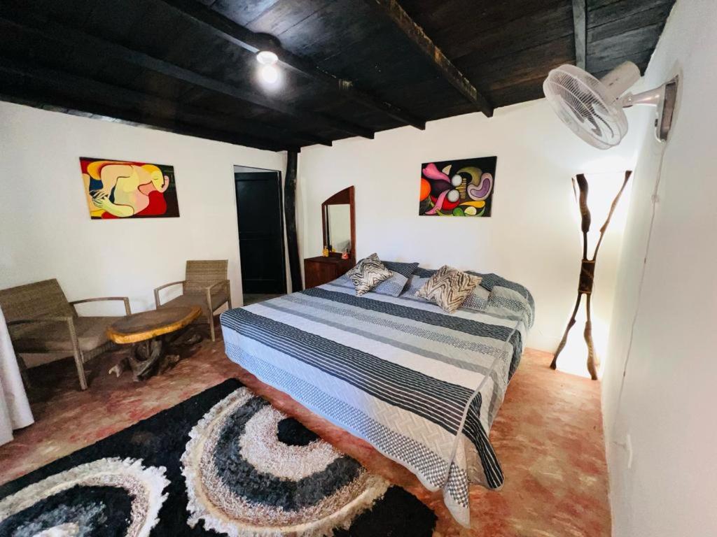a bedroom with a large bed in a room at Minca cabaña la roca in Santa Marta