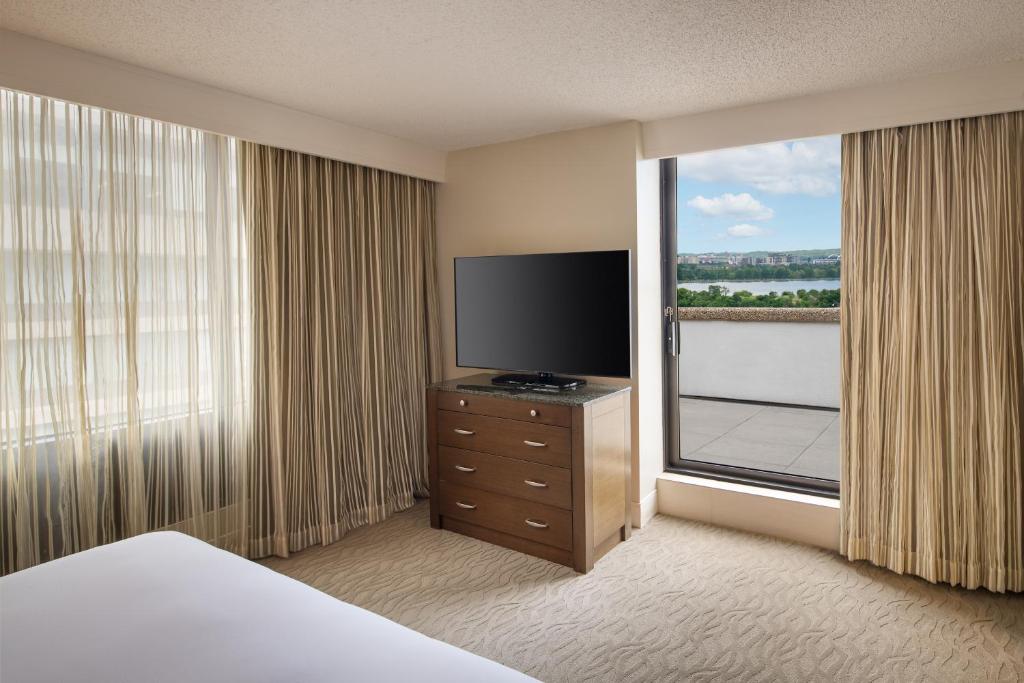 a hotel room with a television and a window at DoubleTree by Hilton Washington DC – Crystal City in Arlington