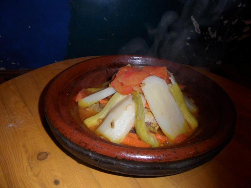 a bowl of food on a wooden table at Gite Ifoulou Tassaout in Ifoulou