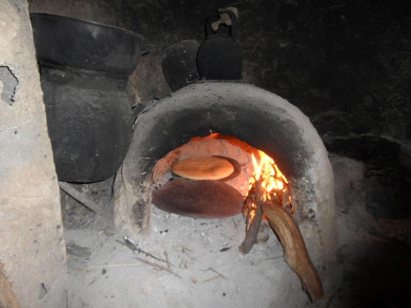 a brick oven with a food cooking in it at Gite Ifoulou Tassaout in Ifoulou