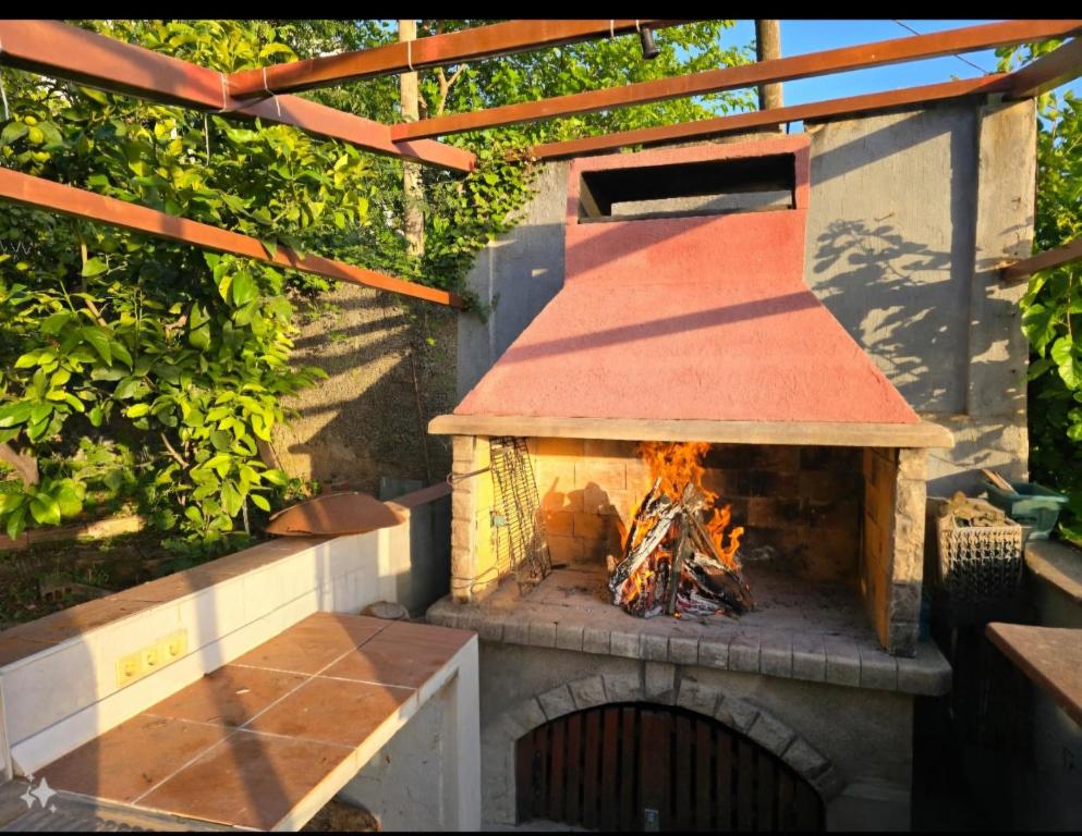 a brick oven with a fire inside of it at GreenGarden in Dubrovnik