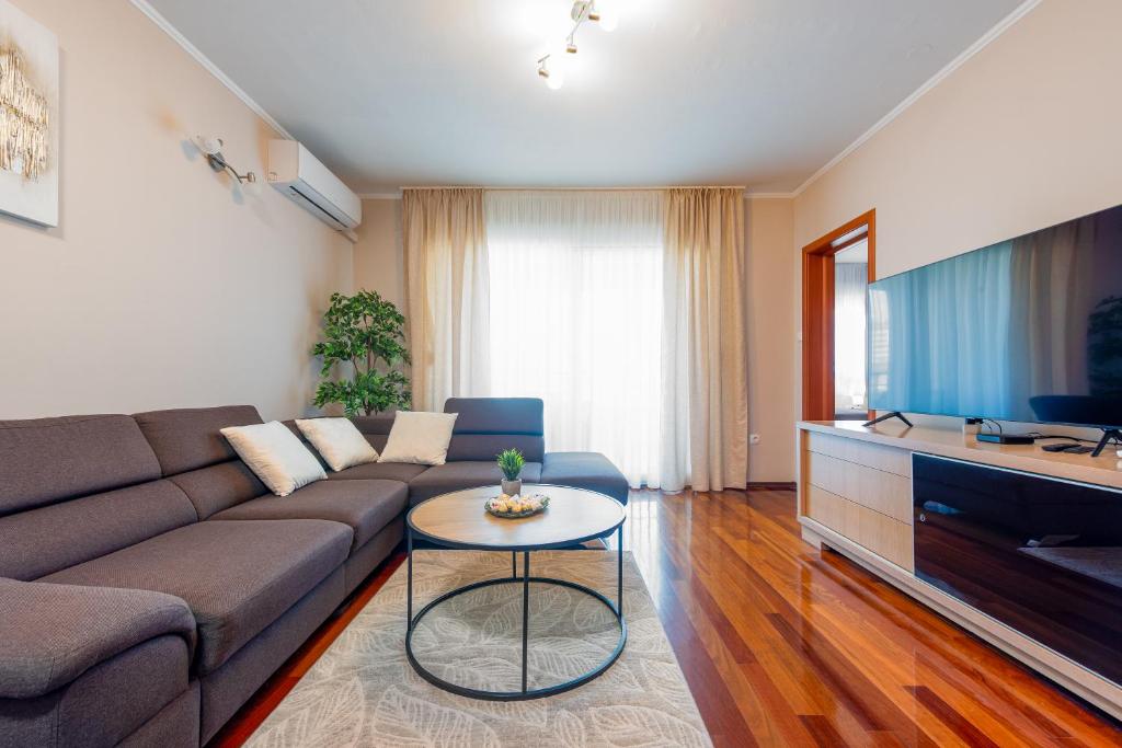 a living room with a couch and a table at Apartment Matea with terrace in Zadar