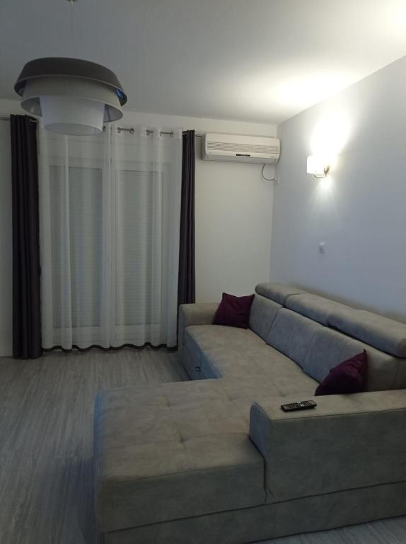 a living room with a couch in a room at A part hn in Herceg-Novi