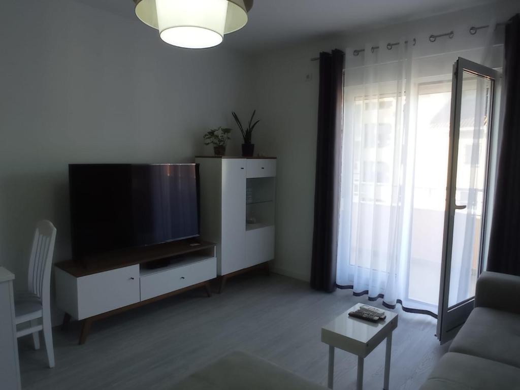 a living room with a large flat screen tv at A part hn in Herceg-Novi