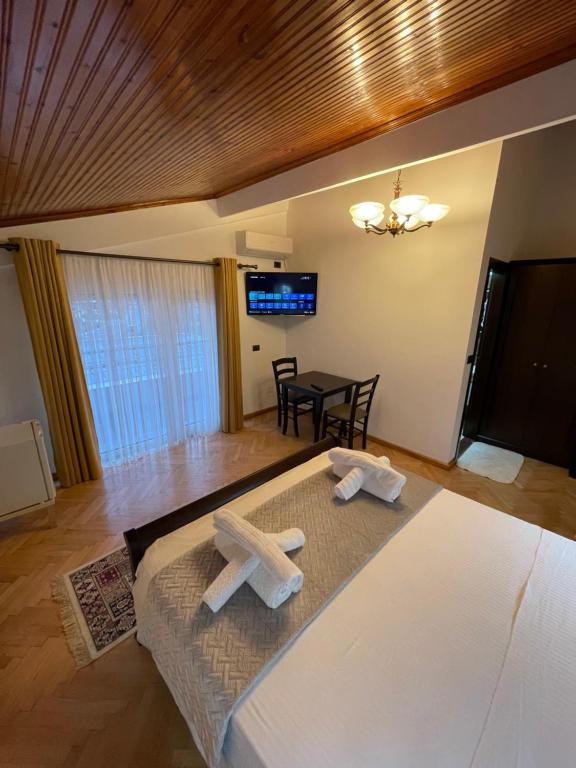 a bedroom with a bed with two crosses on it at Vila AT in Berat
