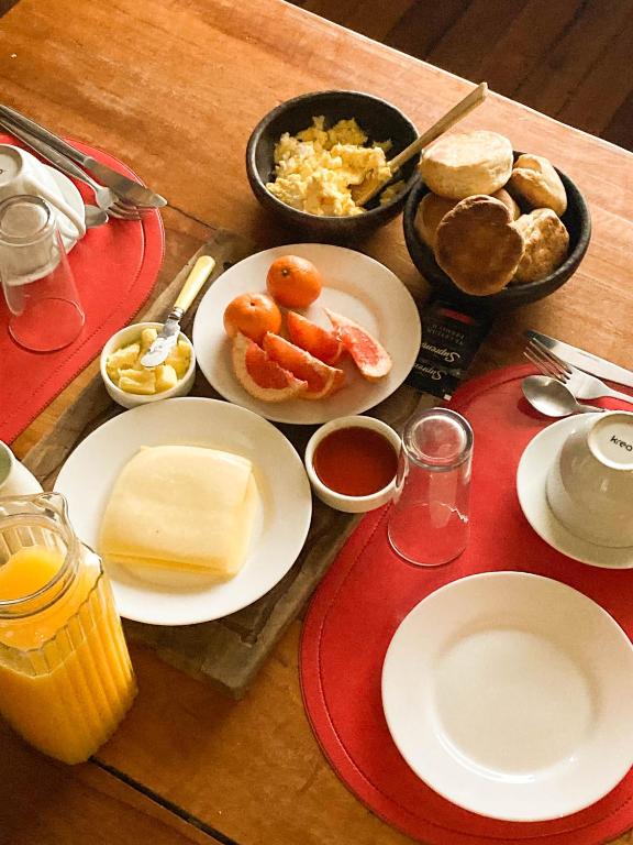 a wooden table with plates of food on it at Hostal Dos Volcanes in Malalcahuello