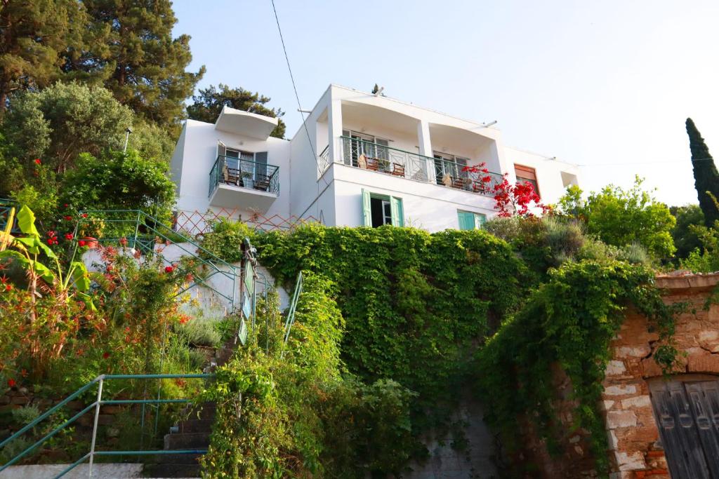 a white house with a hedge in front of it at Atlantis in Samos