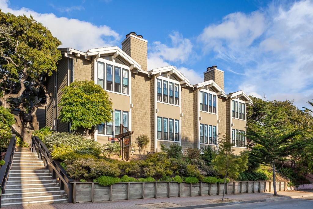 an apartment building with stairs in front of it at Carriage House Inn in Carmel