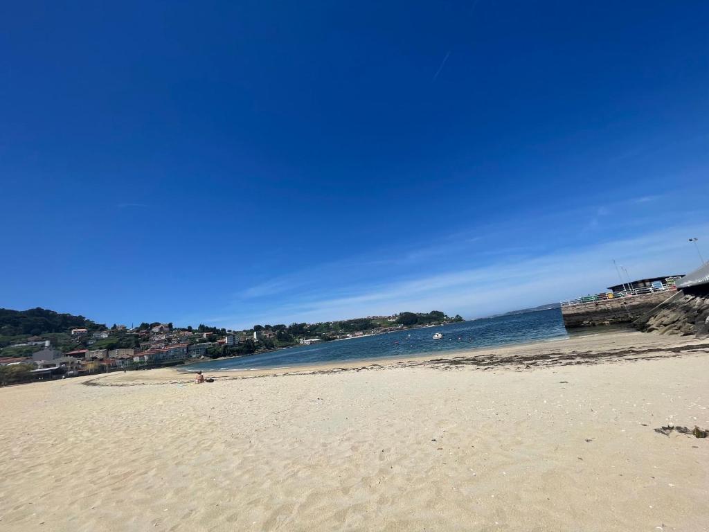 a sandy beach with the ocean in the background at Apartamento Portela in Bueu