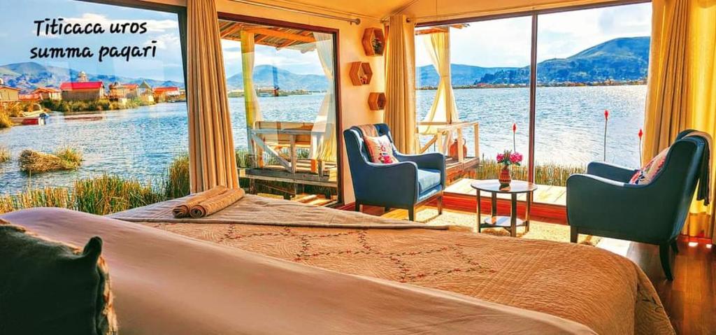 a bedroom with a large bed and a view of the water at Titicaca Uros Summa Paqari in Uros