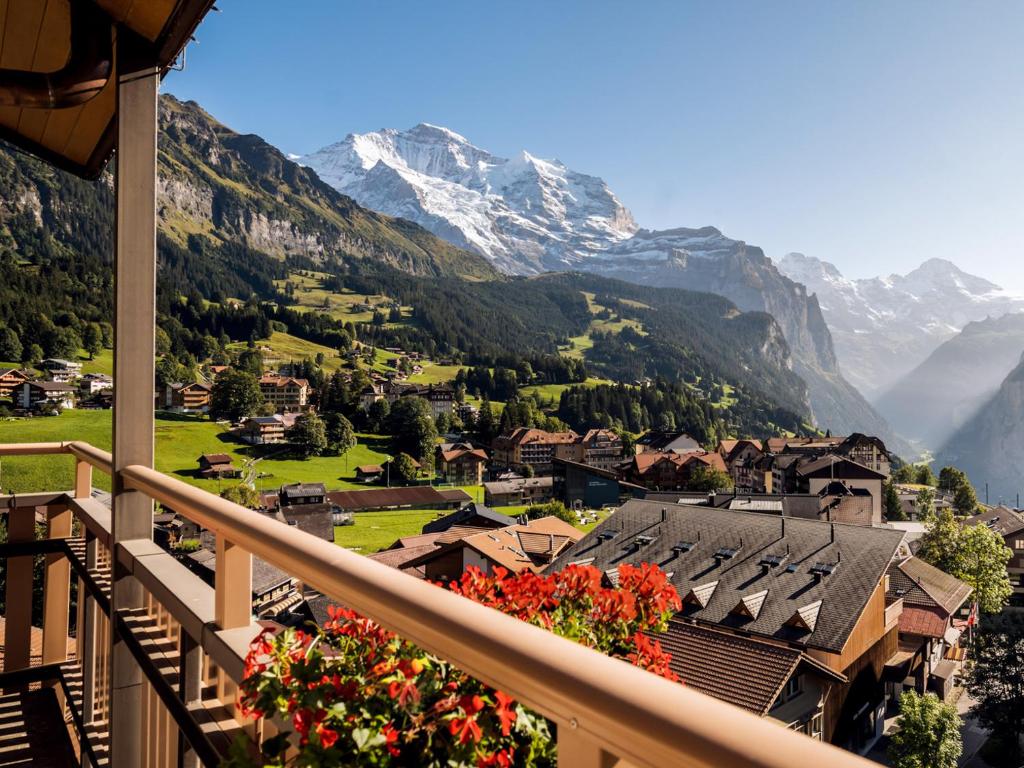 a balcony with a view of a mountain at Hotel Jungfraublick in Wengen