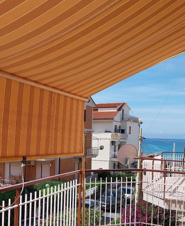 a view of a balcony with awning on a building at Appartamento MareBello in Sperlonga