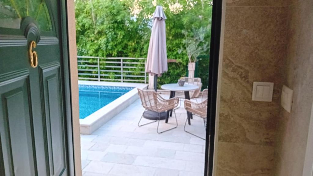 a patio with a table and an umbrella at Square Point Apartments in Kotor