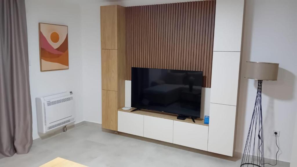 a tv on a cabinet in a living room at Square Point Apartments in Kotor
