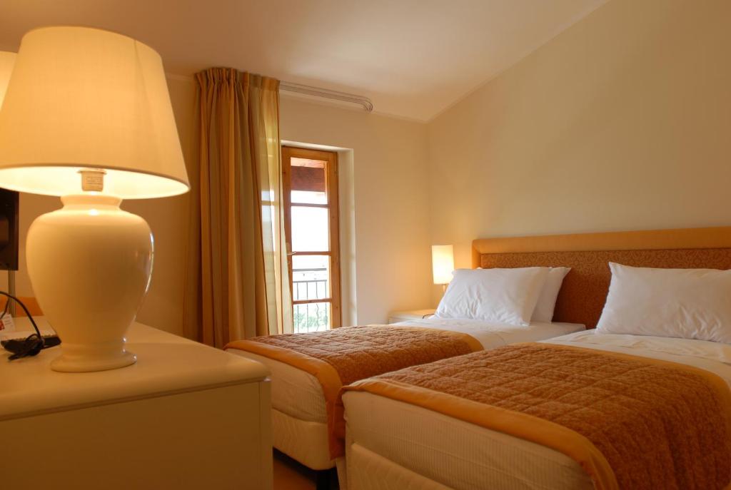 Postel nebo postele na pokoji v ubytování Park Hotel Olimpia