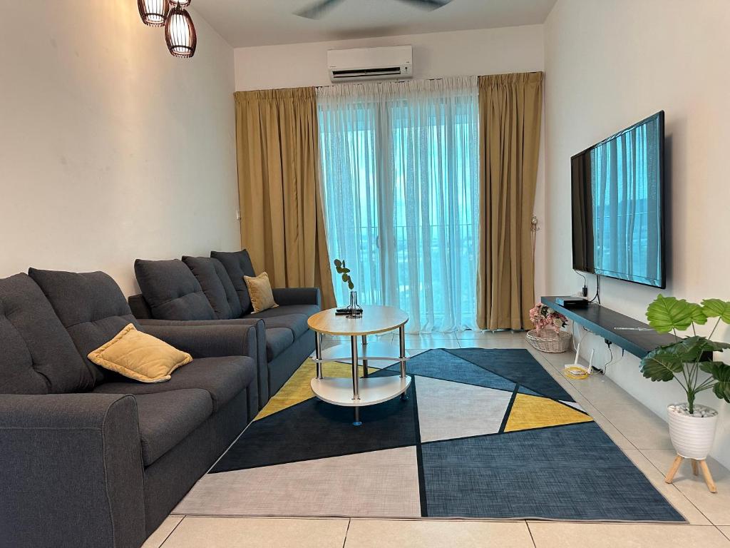 sala de estar con sofá y TV en Holiday Inn Stay 3B2R Meritus Residensi Perai en Perai