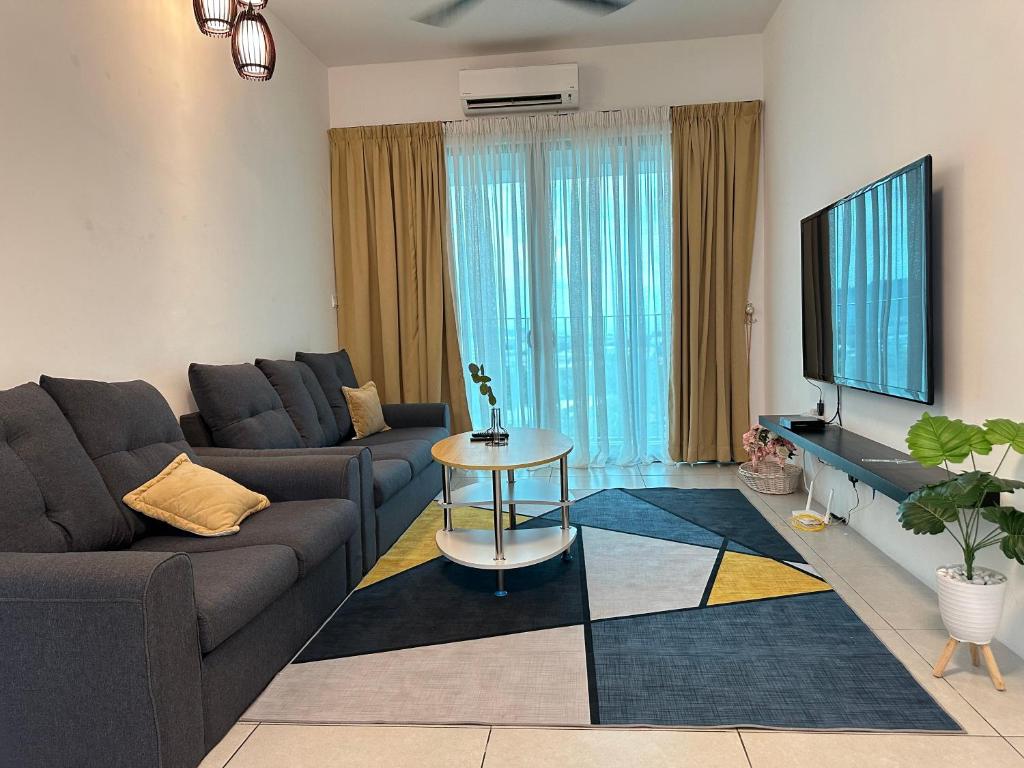 a living room with a couch and a tv at Stay 3B2R Meritus Residensi Perai in Perai