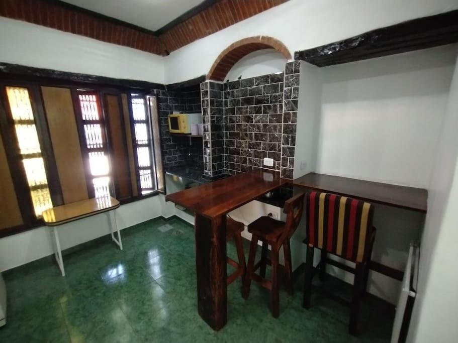 a kitchen with a wooden table and chairs in a room at Pintoresco departamento full equipado in Buenos Aires