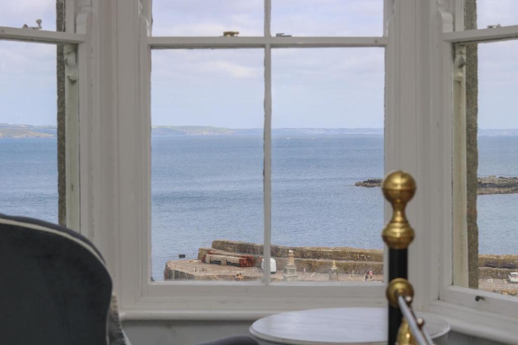 a view of the ocean from a room with a window at Lookout in Mousehole