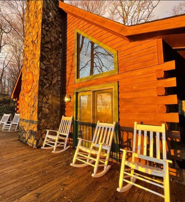 a group of chairs sitting on the front of a cabin at Spacious, dog friendly cabin in Blowing Rock, NC in Blowing Rock