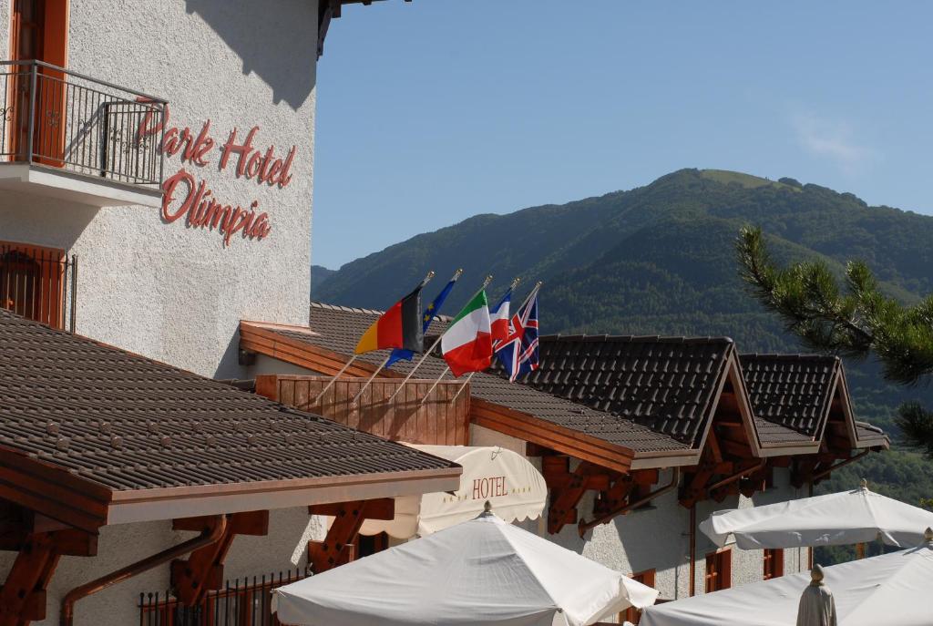 a hotel with flags on the roof of a building at Park Hotel Olimpia in Brallo di Pregola