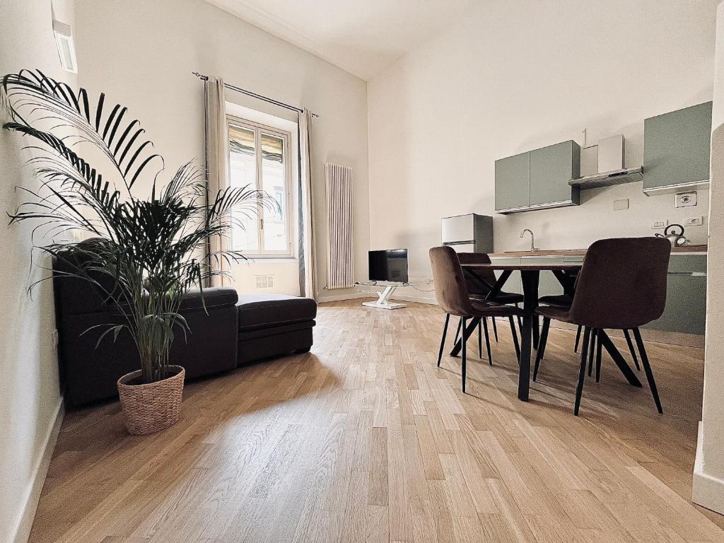 a living room with a table and chairs in a room at Santo Stefano Loft in Bologna