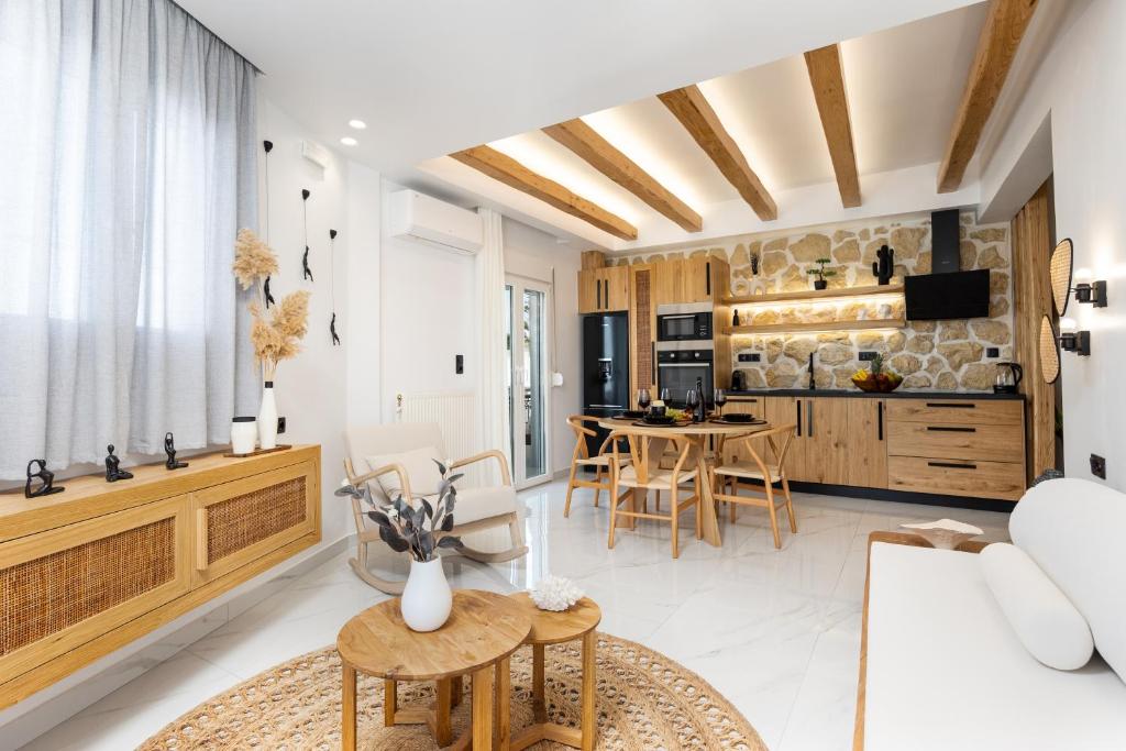 a kitchen and living room with a table and chairs at Lago m Superior Naxos Town in Naxos Chora