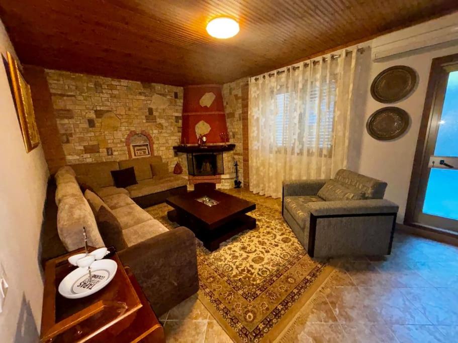 a living room with a couch and a table at Central 2 Floor, Duplex in Elbasan