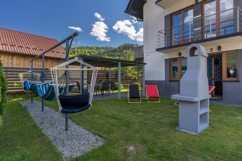 a playground in a yard next to a house at Pokoje Goscinne AnMar in Krościenko