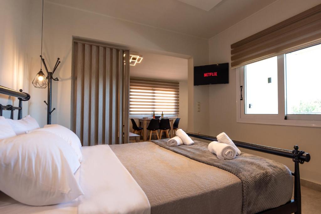 a bedroom with a bed with two pillows on it at Demi&#39;s Apartments Near Athen&#39;s Airport in Artemida
