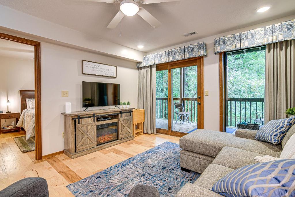 a living room with a couch and a tv at Hike and Leaf Peep! Condo 2 Mi to Silver Dollar City in Branson West