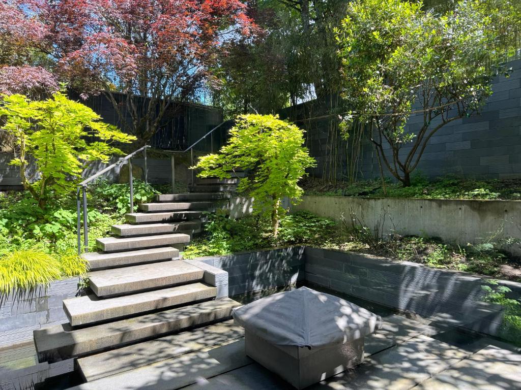 a set of stairs in a garden with a bench at White House in Vancouver