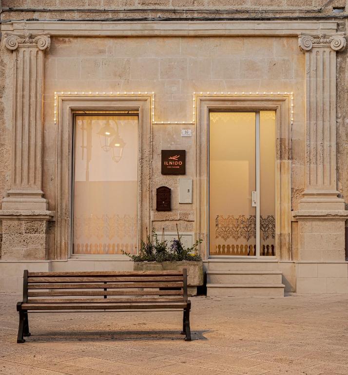 a bench sitting in front of a building at Il Nido Apartment in Montesano Salentino