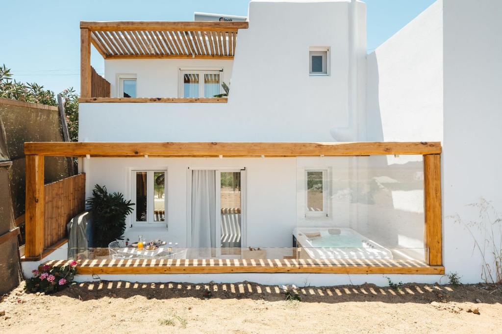 a house on the beach with a swimming pool at Sunday Luxury Suites in Agia Anna Naxos