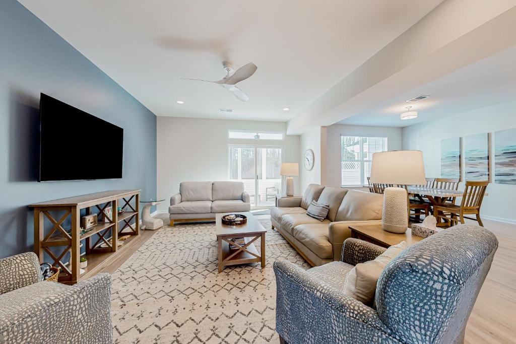 a living room with couches and a flat screen tv at Friendship Creek---33714 Tenby in Frankford