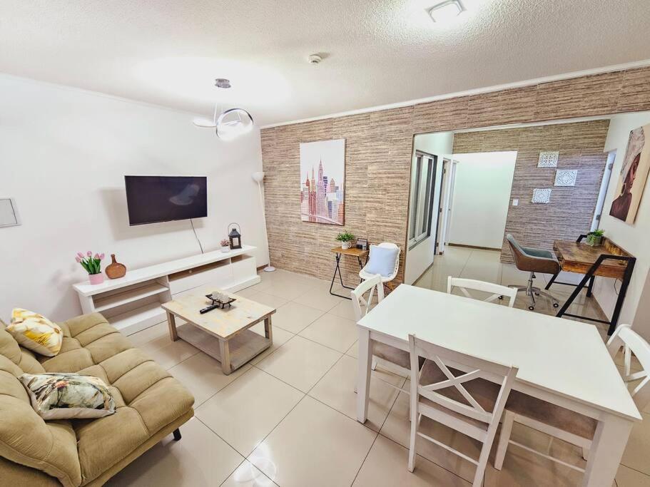 a living room with a couch and a table at Apartamentos y Habitaciones Privadas in Antofagasta