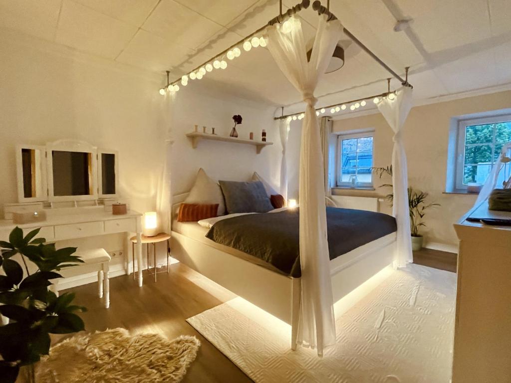 a bedroom with a bed with a canopy at Lot54 Deluxe Apartements in Neidenbach