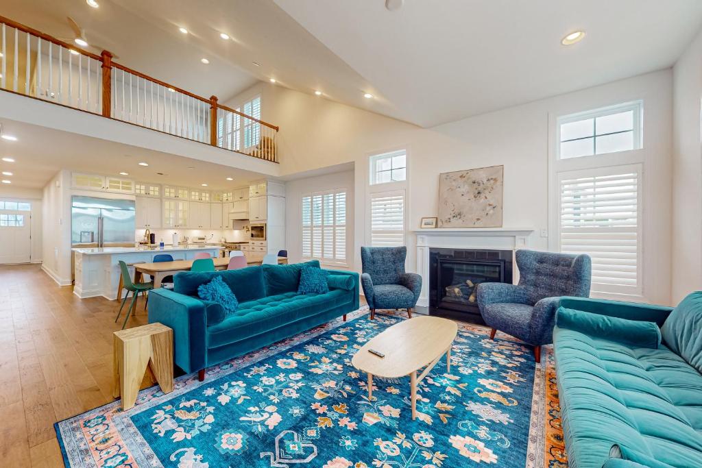 a living room with blue couches and a fireplace at Marlin Chase---30453 Madeira Ln in Ocean View