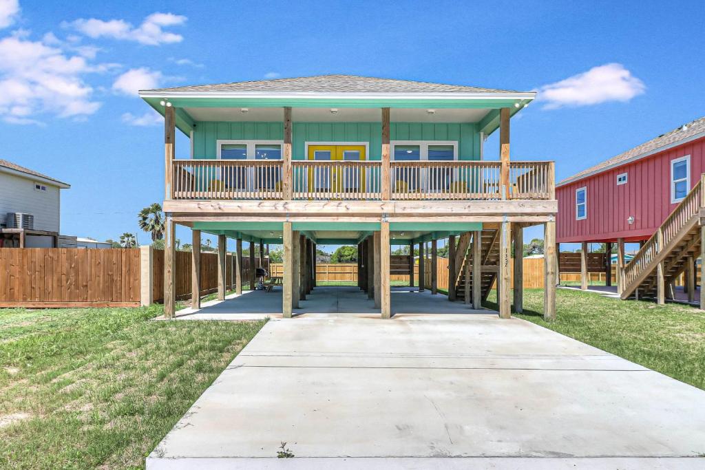 a house with a wrap around porch with a deck at One Fish, Two Fish, Red Fish, Blue Fish in Aransas Pass