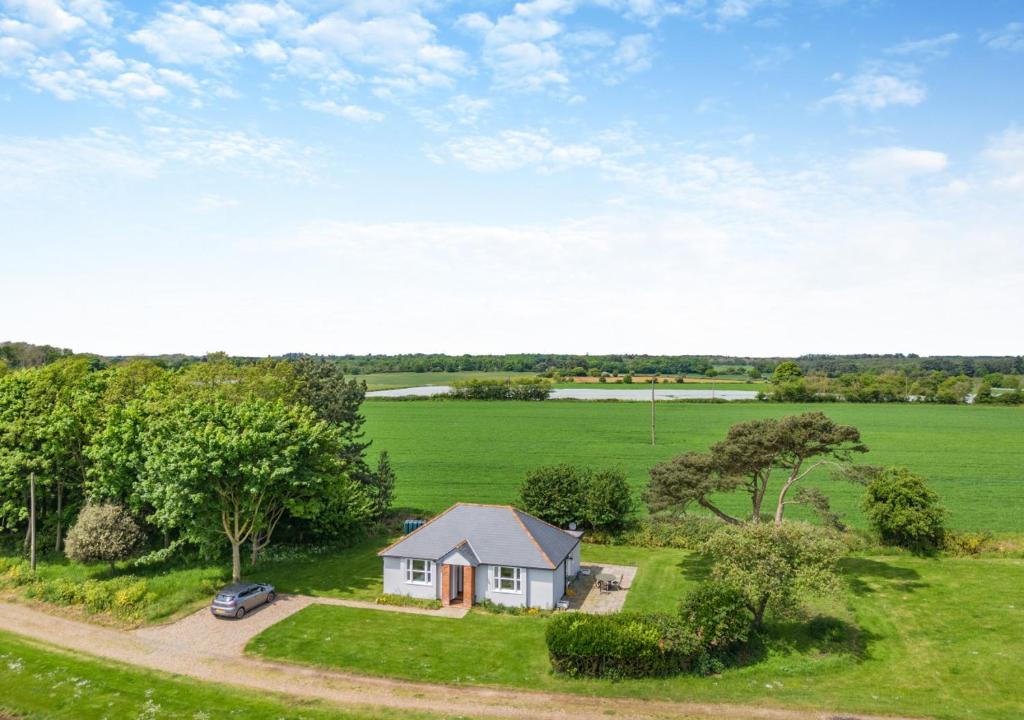 an overhead view of a small house in a field at Lodge Farm Cottage in Sudbourne