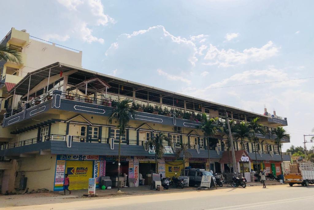 un edificio con palmeras a un lado en Collection O V K Lodge en Mandikal
