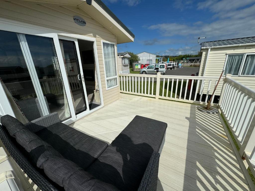 a porch with a bench on a house at Northcott 59, Bude in Poughill