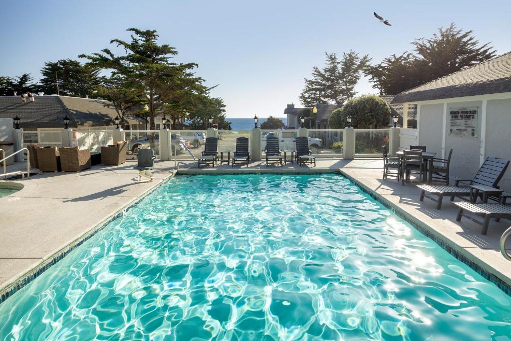 a large swimming pool with chairs at Fogcatcher Inn in Cambria